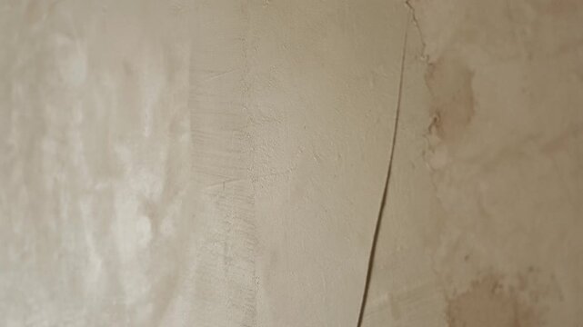 Smoothing plaster on wall surface with float tool close up