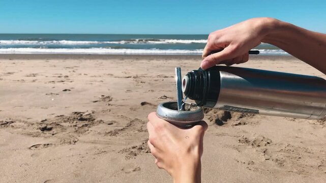 Close Up of Yerba Mate Drink Preparation and Hot Water Pouring on the Beach, Argentina, Tradition, Latin Heritage
