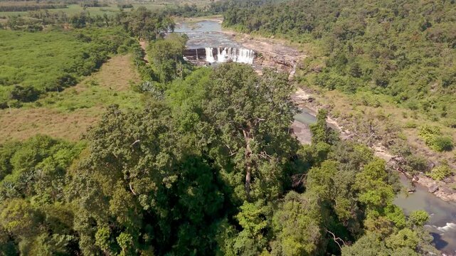 Aerial Drone Footage Flying Over Tree Canopy to Reveal Tad Sepa Waterfall Dense Jungle Attapeu Laos