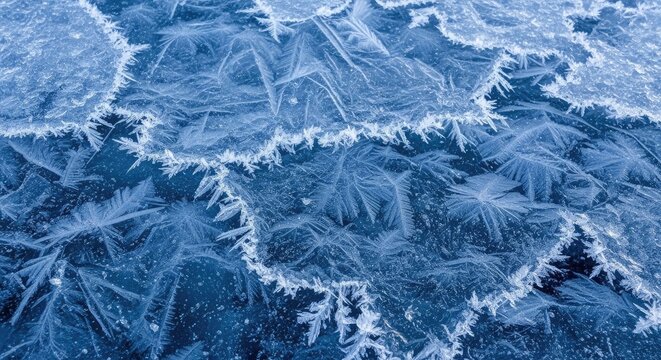 Ice patterns on a frozen lake, with a blue tint, creating a textured and intricate design.