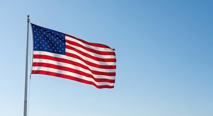 Obraz premium Celebrating independence day american flag waving against a clear blue sky