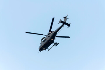 Fototapeta premium Helicopter is flying over isolated blue 
