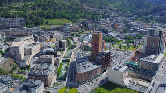 An impressive aerial perspective showcasing Andorra la Vella, the vibrant capital city of Andorra, nestled within the stunning Pyrenees mountains. This footage highlights the unique urban landscape su