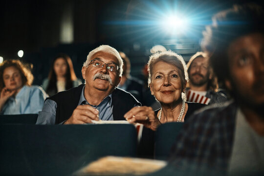 Senior couple enjoying a movie at the cinema