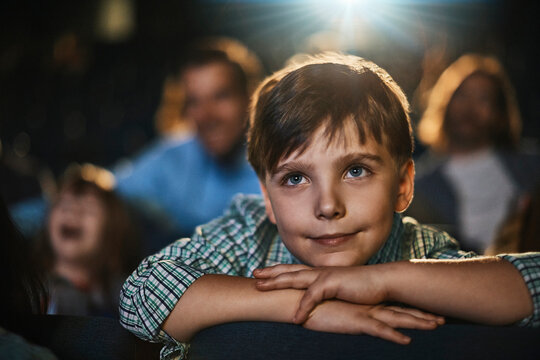 Young boy watching a movie in cinema theater