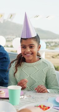 Smile, child and candy at party outdoor for birthday, celebration and social gathering. Happy, kid and eating sweets with dessert, family event and bonding together for milestone at special occasion