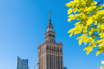 Obraz premium Historic clock tower rising against clear sky in city. The Palace of Culture and Science, Warsaw