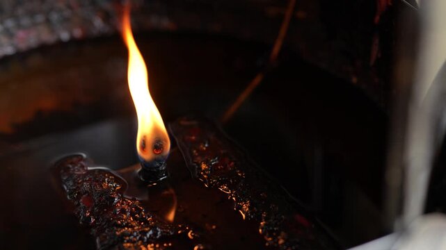 Traditional oil lamp at a Chinese shrine used for lighting incense.