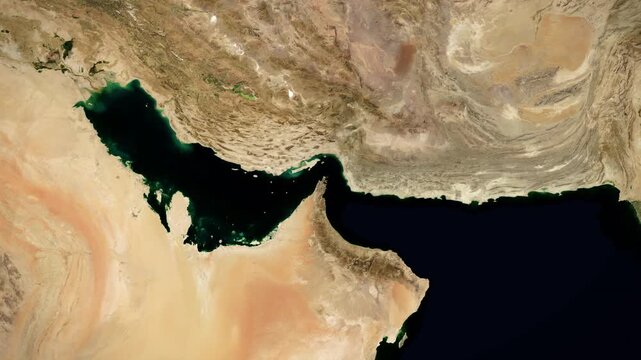 Camera zooms into the Strait of Hormuz on a satellite map. Map showing the location of Iranian blockade of the important oil and cargo shipping route. Iran War