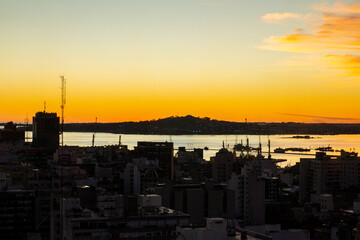 Naklejka premium Photo of the hill of Montevideo at sunset with an orange sky