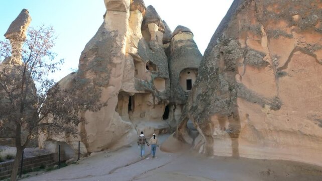Wander through the stunning rock formations and ancient caves of Cappadocia, Turkey. Experience this unique landscape as the golden light of sunset casts captivating shadows.