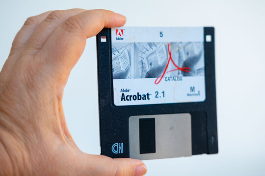 Vintage 3.5 inch floppy disk Adobe Acrobat 2.1, Macintosh version computing, digital history, software tech artifact, retro tech nostalgia, analog and digital storage, old school computing history