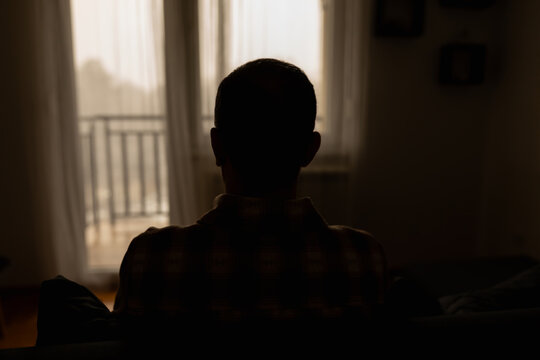 Man with headache, depression, sadness and loneliness at home