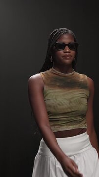 Fashion model, woman and walk with sunglasses on runway for style showcase, couture or brand design. Catwalk show, audience and trendy wardrobe on stage for summer collection, designer and confidence