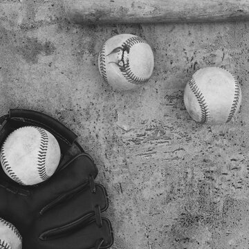 Baseballs with glove from top view in black and white showing texture of used sports equipment in black and white, copy space on square background.