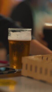 Woman drinking fresh draft beer at pub