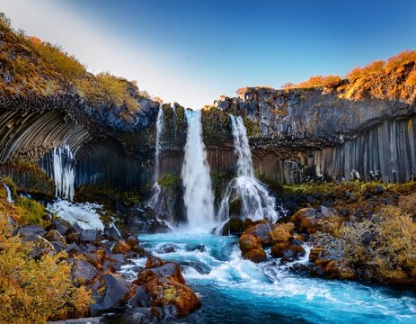 discover the stunning barnafoss and hraunfossar waterfalls as crystal clear water cascades over rugged rocks