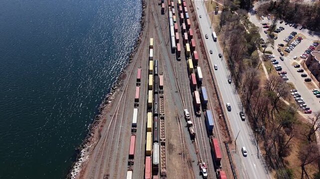 Aerial View Railway Freight Train With Containers Moving Through Halifax Nova Scotia Canada Passing Urban Areas Bridges And Houses Industrial Logistics Transportation Scene