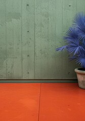 Naklejka premium Muted green concrete wall and orange floor background with a potted blue palm plant for interior design lifestyle branding, architectural mockups and minimal web banners