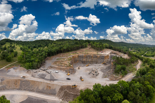 Industrial open-pit mining site with limestone quarry at mountain hillside