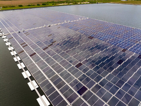 Innovative floating photovoltaic panels on water surface generating renewable electricity. Environmentally friendly solution for sustainable energy production without land use or carbon emissions