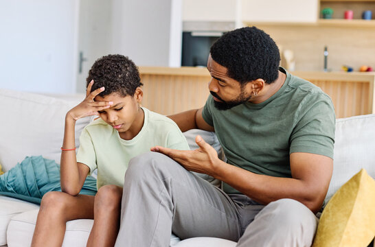 Portrait of a teenage boy son talking to his father at home. Sharing secrets and problems, support and parenthood concept