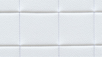 Fototapeta premium The surface texture of white faux leather, stitched in diamond, square, and rectangular patterns. Quilted eco-leather