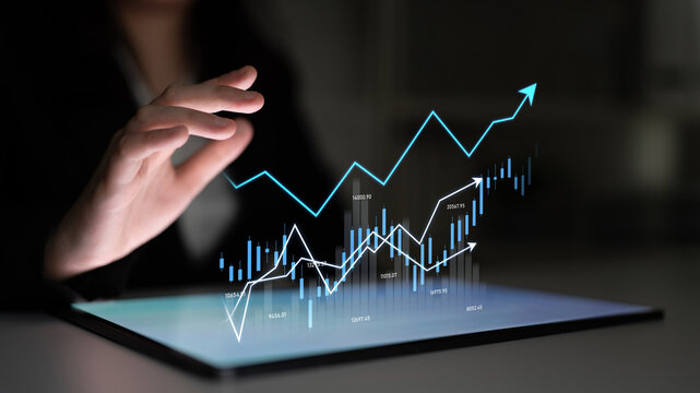 A business professional interacts with digital graphs and statistics on a tablet, showcasing the trends and growth in a modern corporate environment. Scalp