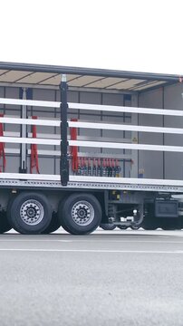 Person remove curtain from truck trailer in slow motion