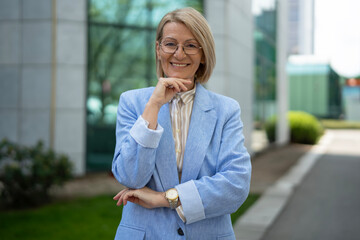 Fototapeta premium Confident mature businesswoman smiling looking at camera