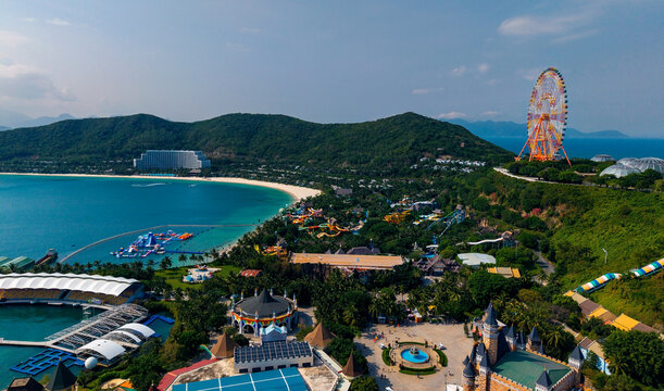 Aerial view of coastal amusement park with ferris wheel and beach, travel trip Nha trang, Vietnam