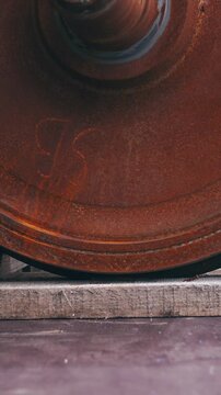 Dropping train wheelbase on wooden holders close-up