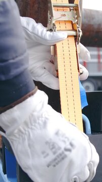 Tying up the wheelbase cargo on pallet close-up slow motion
