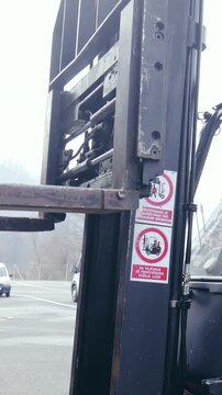 Forklift carefully picking cargo from trailer