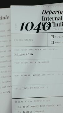 Income tax return document with personal identification fields being filled in
