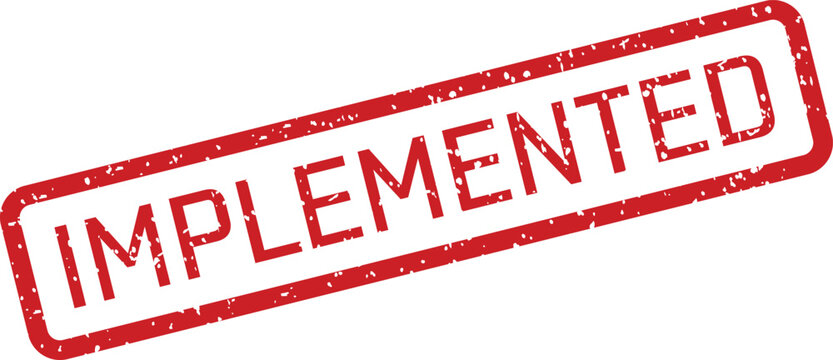 A textured red rectangular rubber stamp clearly showing the capitalized word IMPLEMENTED on a plain white surface