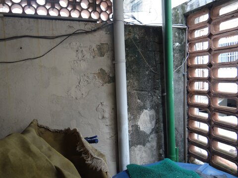 Plumbing Pipes and Peeling Paint on Weathered Wall