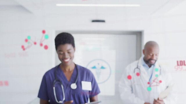 Nurse walking ward on tablet ping showing vitals overlay for review while doctor checking clipboard
