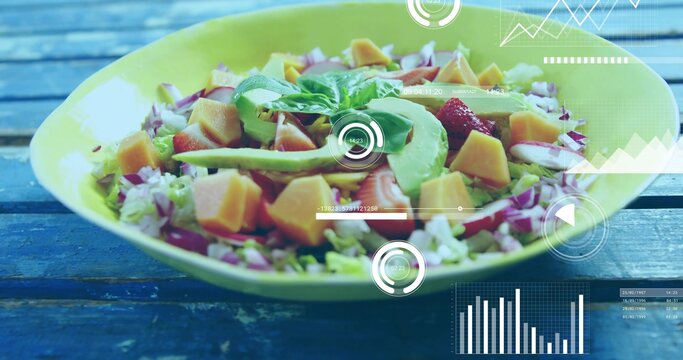 Showing big pale-green bowl resting on blue table, with avocado mango tomato basil and HUD overlays