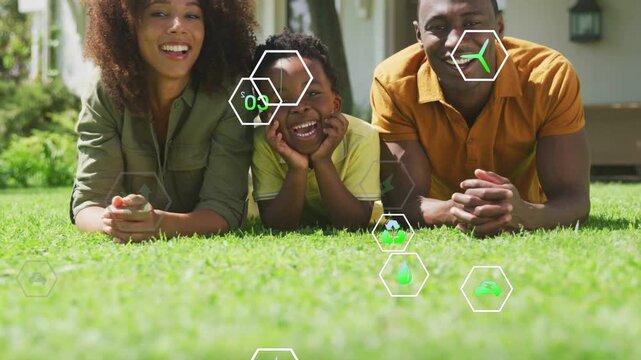 Parents and child lying yard, eco hexes appearing, clustering near faces, promoting energy savings
