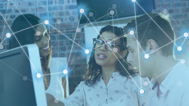 Team at monitor, woman pointing and explaining, leading to overlaid nodes growing for data analysis