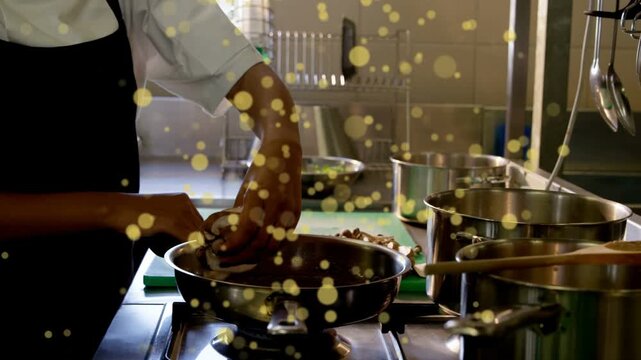 Kitchen chef slicing mushrooms on board, moving into frying pan cooking, bokeh floating over hands