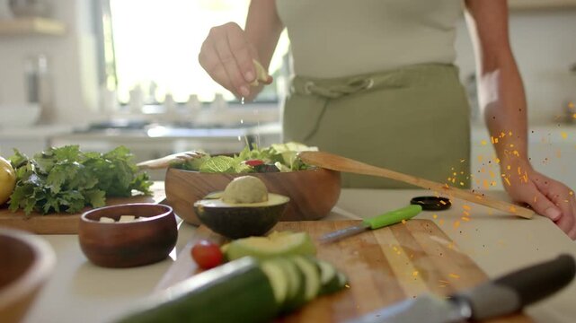 Cook pinching lemon and drizzling oil over salad to dress, animated labels tagging food near hands
