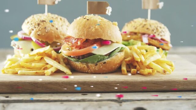 Camera pulling back, revealing three mini buns with fries, confetti moving, showing textures