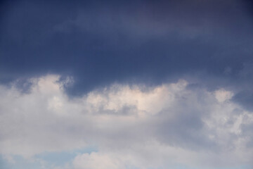Fototapeta premium Dark blue sky with layer of white and grey clouds in lower part of frame panoramic view