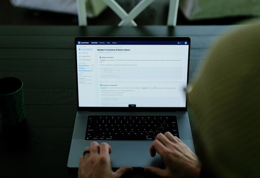 Older male university student receives alert warning notification for violating academic integrity policies by using AI chatbot for assignment concept