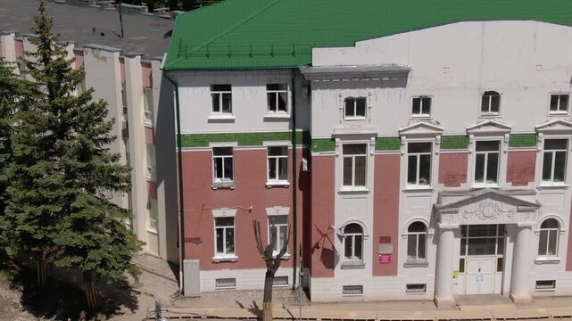 Drone lateral flight past building and street