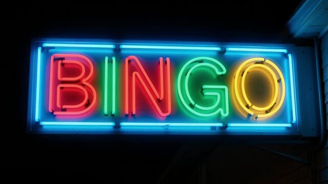 Panning shot of neon bingo sign slowly glowing on storefront exterior at night with colorful tubular lights and dark background