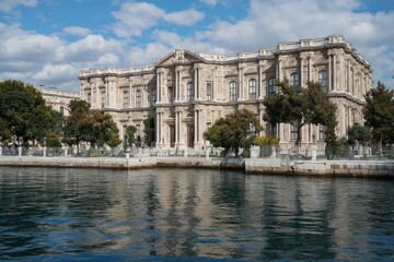 Fototapeta premium Grand historic palace by the waterfront under blue sky