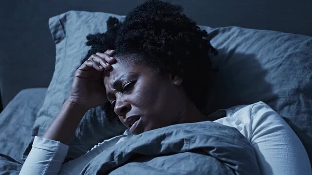 Woman Experiencing Head Pain In Bed At Night, Showing Symptoms Of Insomnia Or Migraine